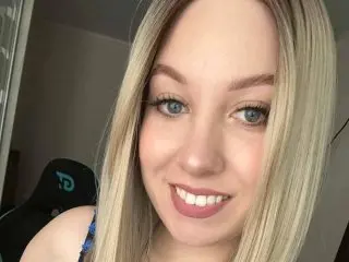 Luna_Gaze smiles close-up, showing her blonde hair and light eyes in a headshot.