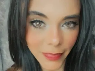 MhiaSweet poses close-up, showing her face and long dark hair with a soft, direct gaze.