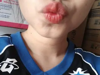 MiaBaba wearing a blue and white athletic jersey, looking directly at the camera with a pouting expression on her lips.