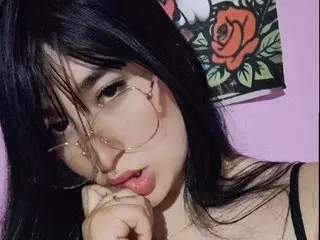 MiaaOwens poses with long black hair and a direct gaze, showing her face and shoulders against a purple background.