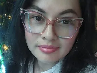 Miasantana18 — Miasantana18 wearing pink glasses and looking at the camera with a slight smile.