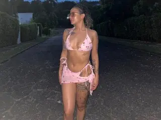 Misshannadirty poses outdoors at night wearing a pink polka-dot bikini, showing her chest and stomach.