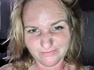 MrsRuehlen poses close-up, showing her face and blonde hair with a direct gaze at the camera.