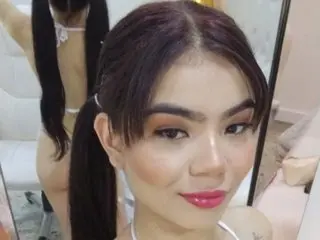 Nahia69 poses with her dark hair pulled back, showing her face and shoulders in a close-up shot.