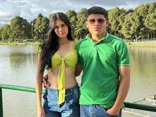 NattyQueen26 poses outdoors in a yellow halter top and denim shorts, showing her midriff and long dark hair.