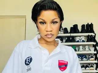 Nicki69 — Nicki64 has short black hair and wears a white collared shirt while looking directly at the camera.