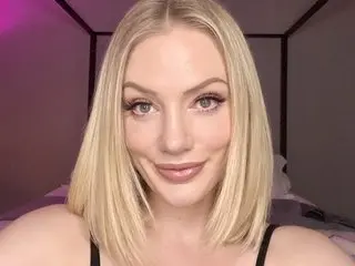 QuinnHart poses with a soft smile, showing her blonde hair and clear skin in a close-up headshot.