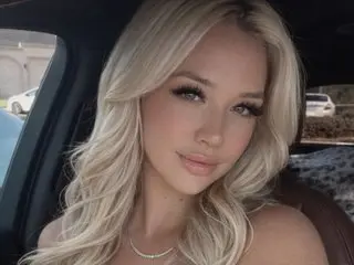 Sabrina_xx poses with her long blonde hair down, looking directly at the camera in a close-up headshot.