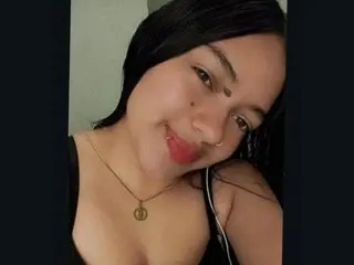SamanthaLopez19 smiles while wearing a black tank top, showing her dark hair and face in a close-up selfie.