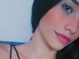 Samanthafinexxox looks at the camera with long dark hair and pink lipstick, showing her face and neck against a plain background.
