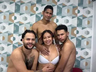 Happy group of friends in swimwear posing together against a geometric patterned wall.