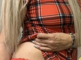 SavannahSlater poses in a red plaid shirt, pulling the fabric down to show her bare skin and stomach.