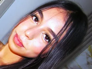 ScarletVidal looks directly at the camera with long dark hair framing her face.