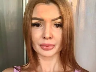 SeductiveCelinny looks directly at the camera with long, straight reddish-brown hair and pink lipstick, posing in a close-up shot.