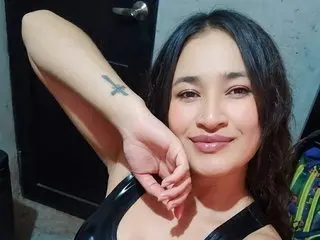 Shantal_slav poses with one arm raised, showing her face and bare shoulders with long dark hair and a slight smile.