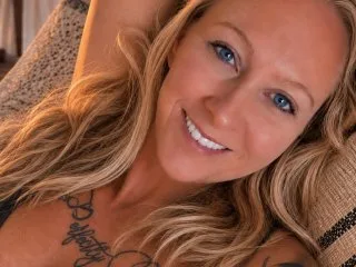 Shaylin_Miller — Shaylin_Miller smiles while running her hands through her long blonde hair.