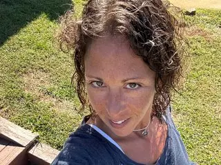 SoVeryDifferent shows her curly brown hair and face while looking directly at the camera in an outdoor setting.