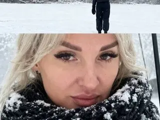 Sofi_sofi_23 poses for a close-up selfie outdoors in the snow, wearing a thick black and white knit scarf.