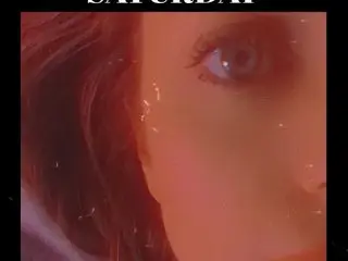 StaceeJean444 looks into the camera with a close-up view of her eyes and face, showing her dark hair and skin under warm red lighting.