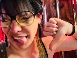 Terahole sticks out her tongue while looking at the camera, showing her dark hair and face in a close-up shot.
