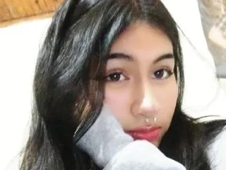 TifanySkinny looks into the camera with long dark hair and a direct gaze.