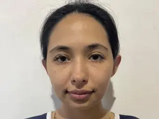 Vane_Lovx looks directly at the camera with her dark hair pulled back, showing her face and bare shoulders against a plain white background.