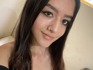 Violet_Graace — Smiling young woman with long dark hair and nose ring in a bright indoor setting.
