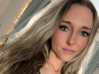 Violet_Styles poses for a close-up selfie, looking into the camera with her long blonde hair flowing over her shoulder.