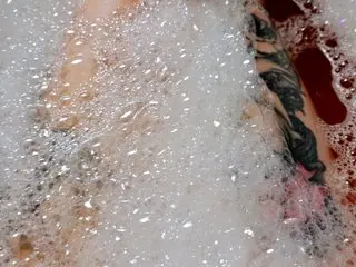 Vixie_Pixie's body is partially covered by thick white soap bubbles in a close-up shot.