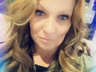 XMileyMooreX poses close-up with her long blonde hair framing her face and a direct gaze at the camera.