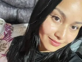 celestemarinn smiles while looking into the camera with her long black hair framing her face.