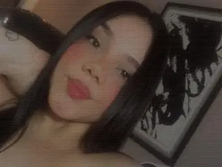 chelsea_27 shows her long dark hair and face in a close-up selfie shot against a dark background.
