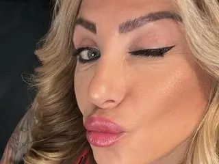 cococheri winks at the camera, showing her blonde hair and face in a close-up shot.