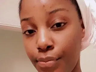 essyasha24 looks directly at the camera with a close-up headshot, showing her face and dark hair pulled back.