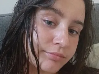 freakylittlebitch69 looks into the camera with wet, dark hair framing her face.