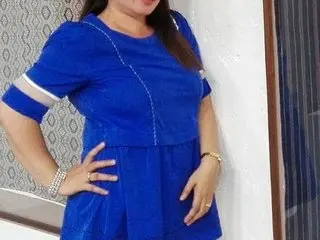 hottypinay51 poses in a blue dress with white trim, showing her hair down and a hand on her hip.