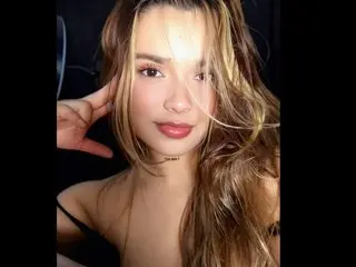 kateZoe poses with her long brown hair framing her face, looking directly at the camera with a soft expression.