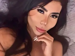 katheryn_fox poses with her hand near her chin, showing her long dark hair and face in a close-up shot.
