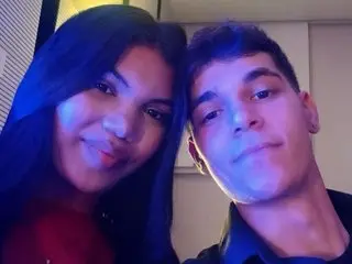 ladygrey77 and a man posing closely together for a selfie under blue lighting.