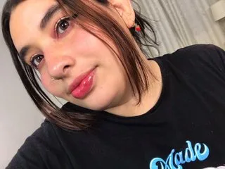 leidyswallow wears a black t-shirt and looks into the camera with pink eyeshadow and glossy lips.