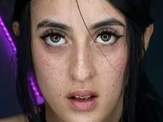 lilith_jeane looks directly at the camera with a close-up headshot, showing her dark hair and eyes.