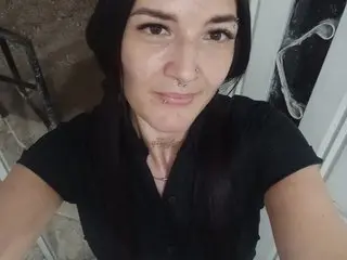madeley29 is a brunette woman with a nose ring wearing a black shirt, looking into the camera.