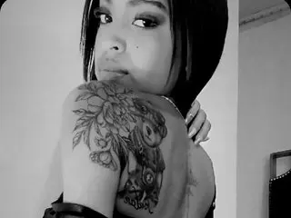 meganstathan shows her shoulder and upper back, displaying a large, detailed rose tattoo on her skin in this black and white photo.