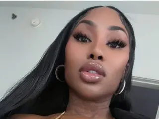 msprincess312 shows her face and long black hair while wearing silver hoop earrings and a direct gaze at the camera.