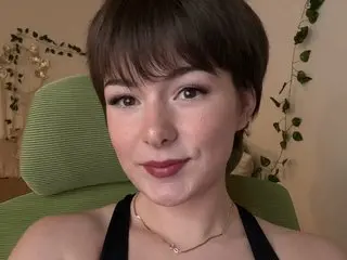 natiwithaphati has short dark hair and a light smile, wearing a black tank top against a soft green background.