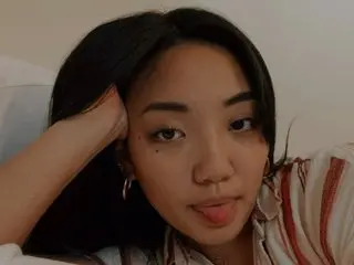orisune — orisune with long dark hair poses close up, looking at the camera while sticking her tongue out slightly.