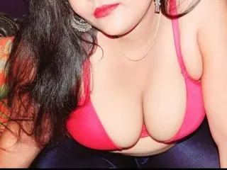 serenalove786 shows off her cleavage in a pink bra, looking directly at the camera with dark hair framing her face.