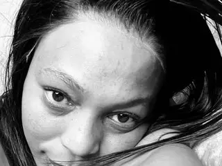 sexytenny looks directly at the camera with a close-up view of her face and dark hair, showing her eyes and skin.