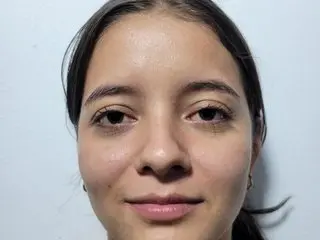 slimfiree poses for a close-up headshot, showing her face, dark hair, and light skin against a plain white background.