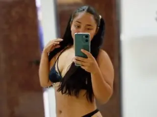 susan_bigass shows off her long dark hair and large breasts in a black bra while posing for a mirror selfie.